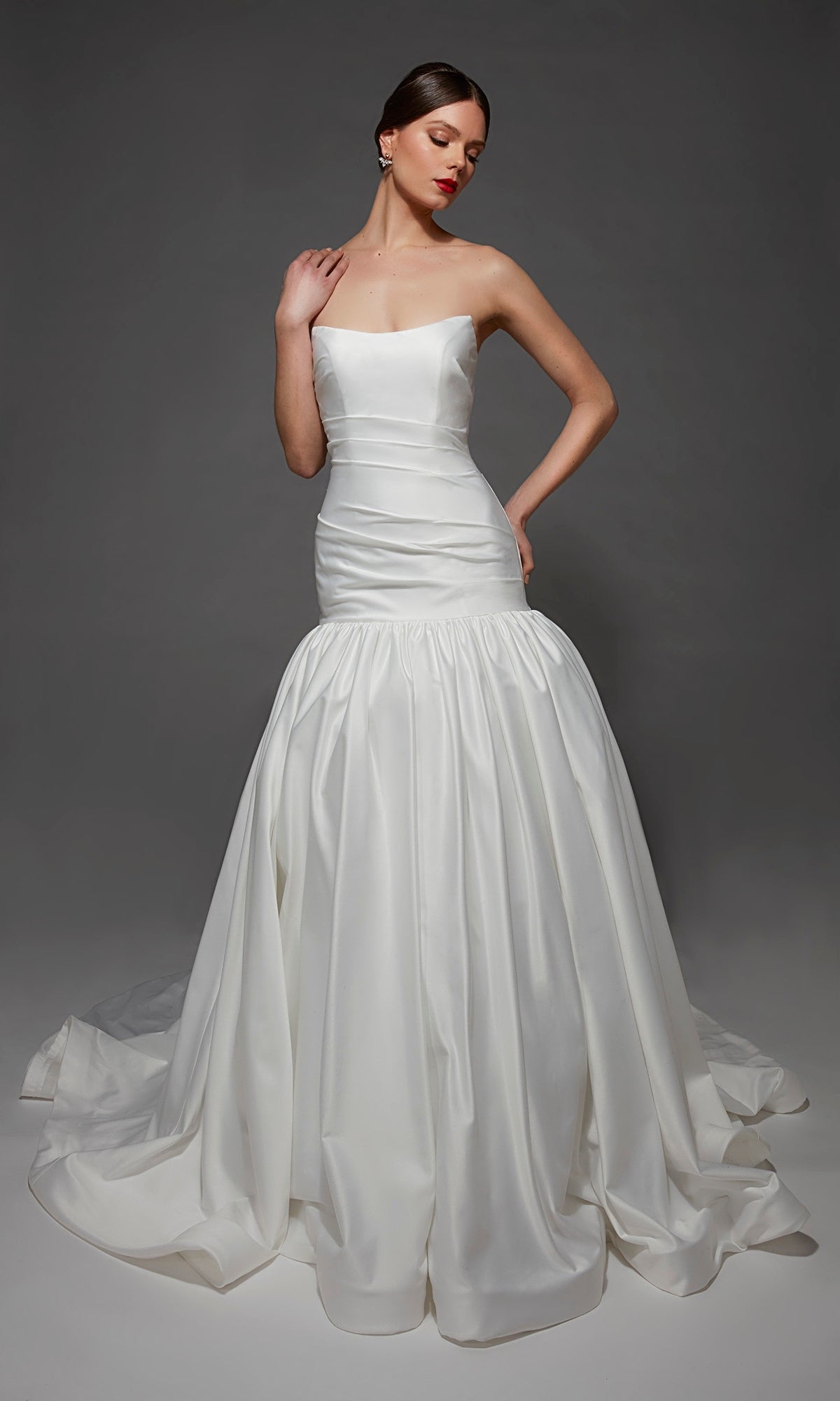 A woman wearing the Long Wedding Dress: Alyce 7181 in Diamond White poses against a plain, dark background.